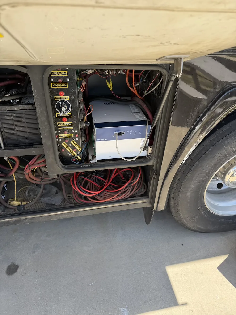 Xantrex Freedom SW inverter/charger and breaker panel in a coach power bay
