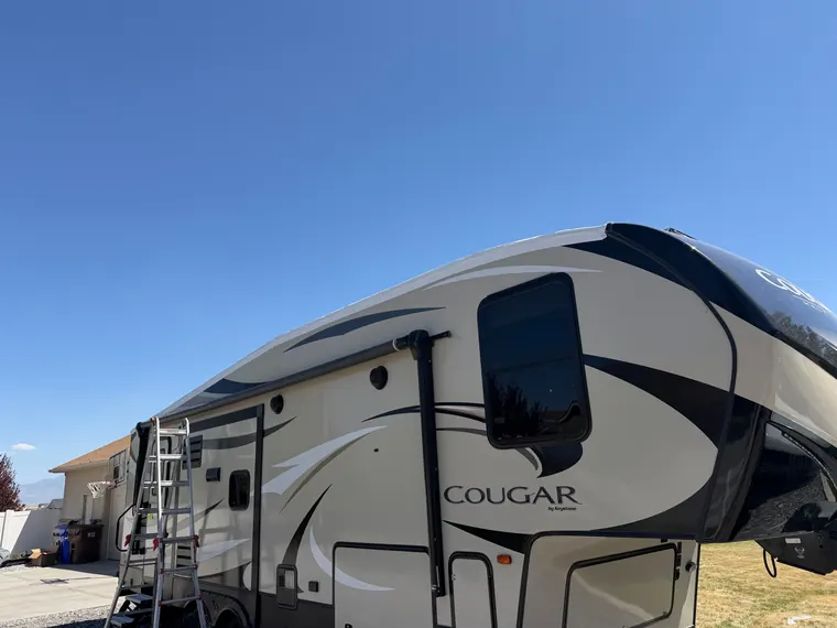 Cougar fifth wheel with the slide-out extended at a customer's home