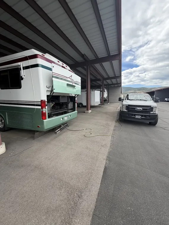 Coach in covered storage with its service bays open