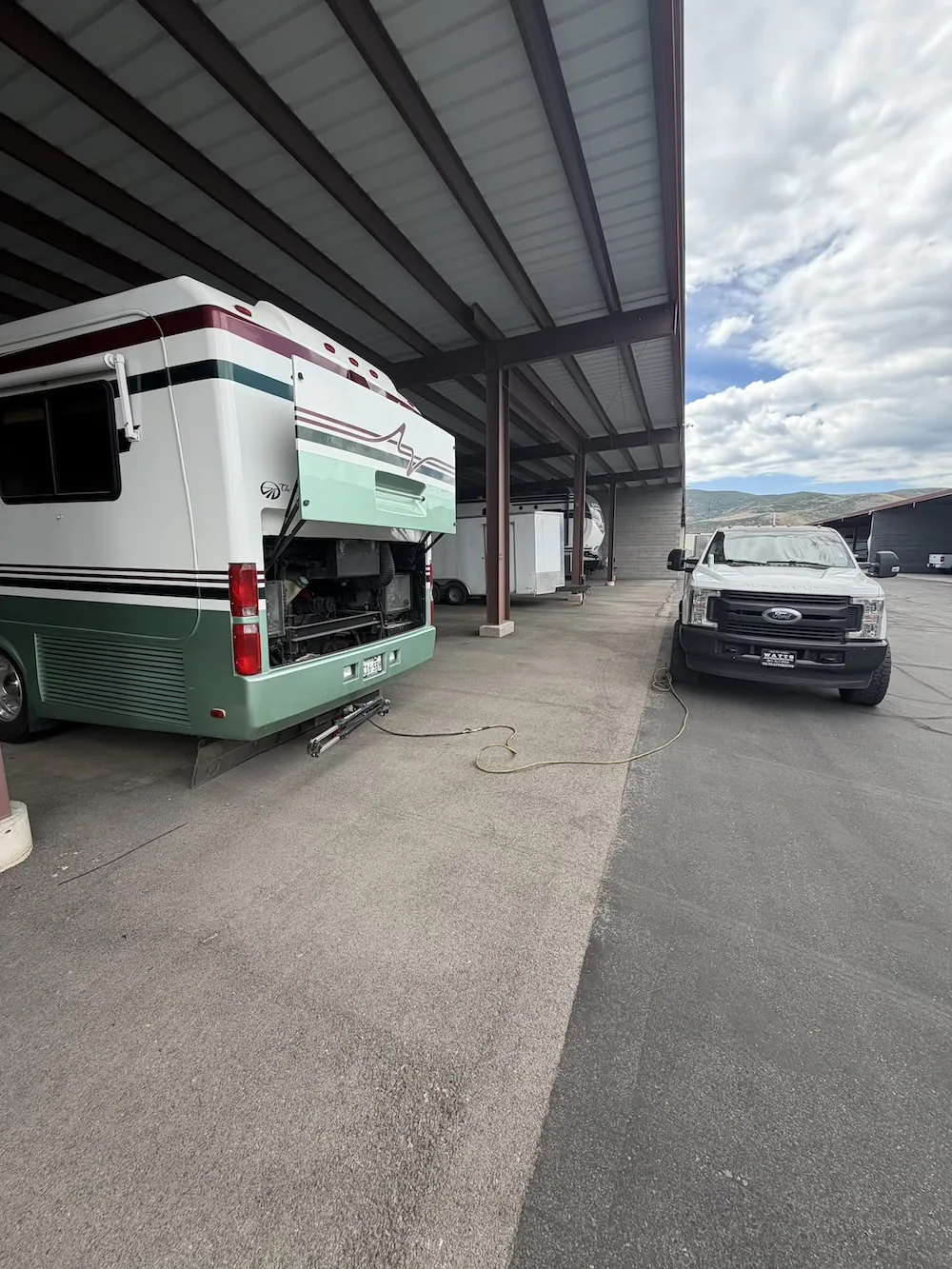 Coach in covered storage with the service bays open